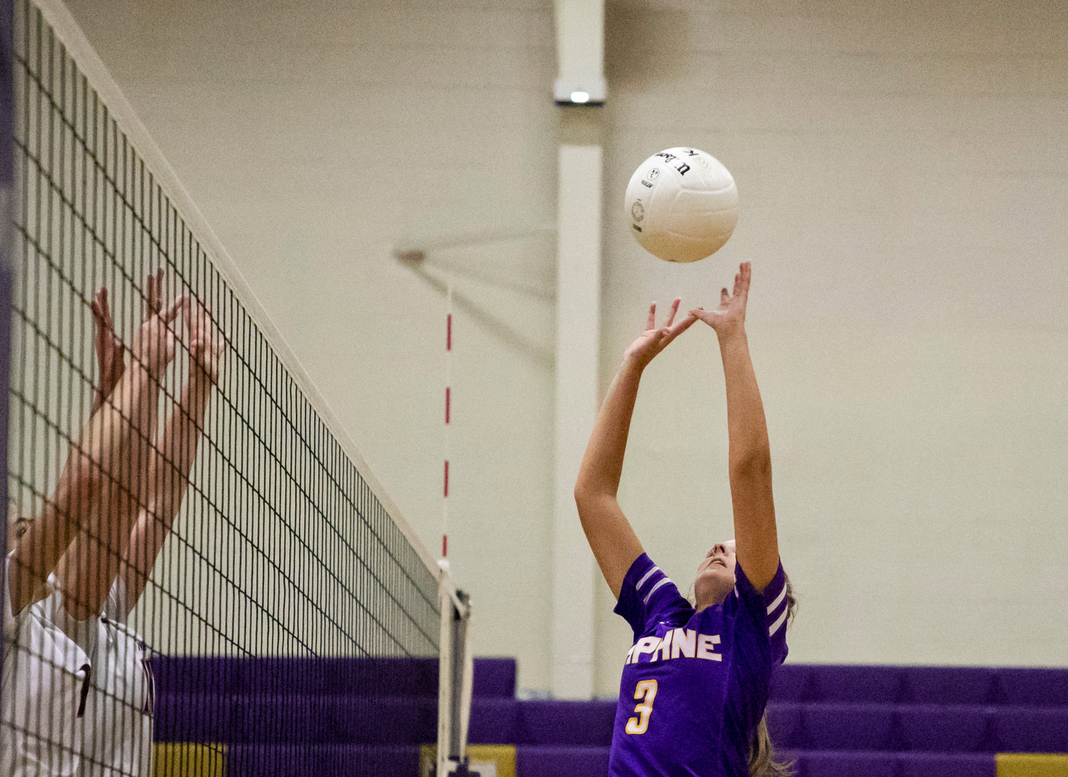 Trojan setter Lucy McCoy makes a play at the net to help quarterback the Daphne offense in its Tuesday match against McGill-Toolen within Class 7A Area 2.