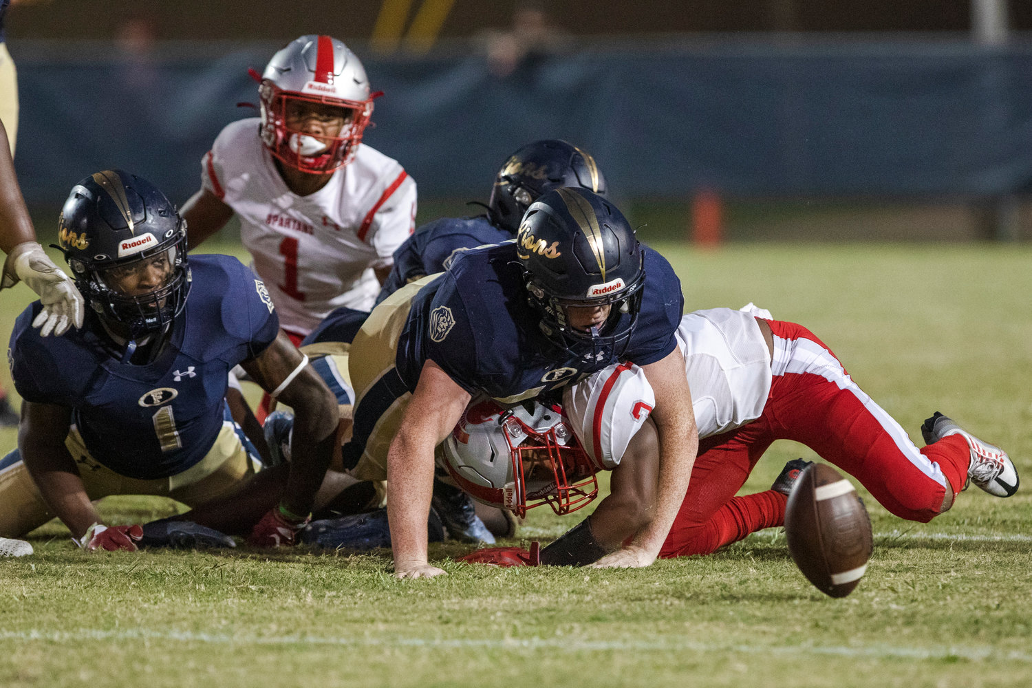 The Foley defense looks to fall on a lost fumble from Saraland’s Ryan Williams during the non-region contest at Ivan Jones Stadium Friday night. The Spartans beat the Lions 49-21.
