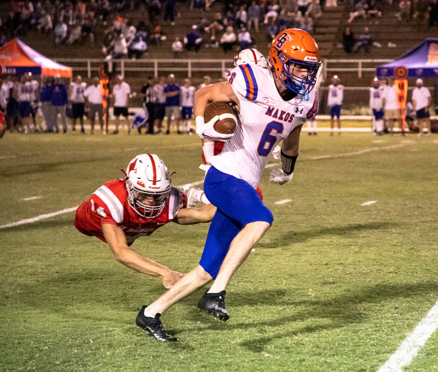 Orange Beach senior Will Reddell sheds a St. Michael defender and looks upfield on a big second-half gain during the Makos’ region contest against St. Michael Thursday on the road. Reddell caught three receiving touchdowns from quarterback Cash Turner on the night.