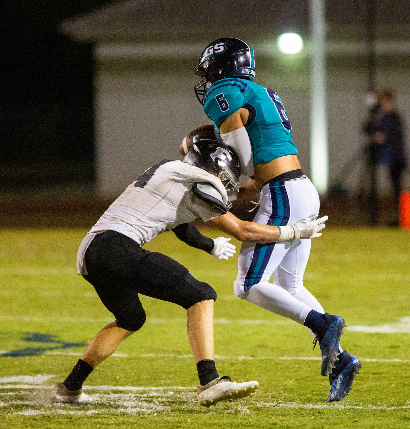 Elberta senior Holden Crook (4) breaks up a pass intended for Gulf Shores senior Bo Lindsey (6) in the first half of the Warriors’ Class 5A Region 1 contest against the Dolphins on the road Thursday night.