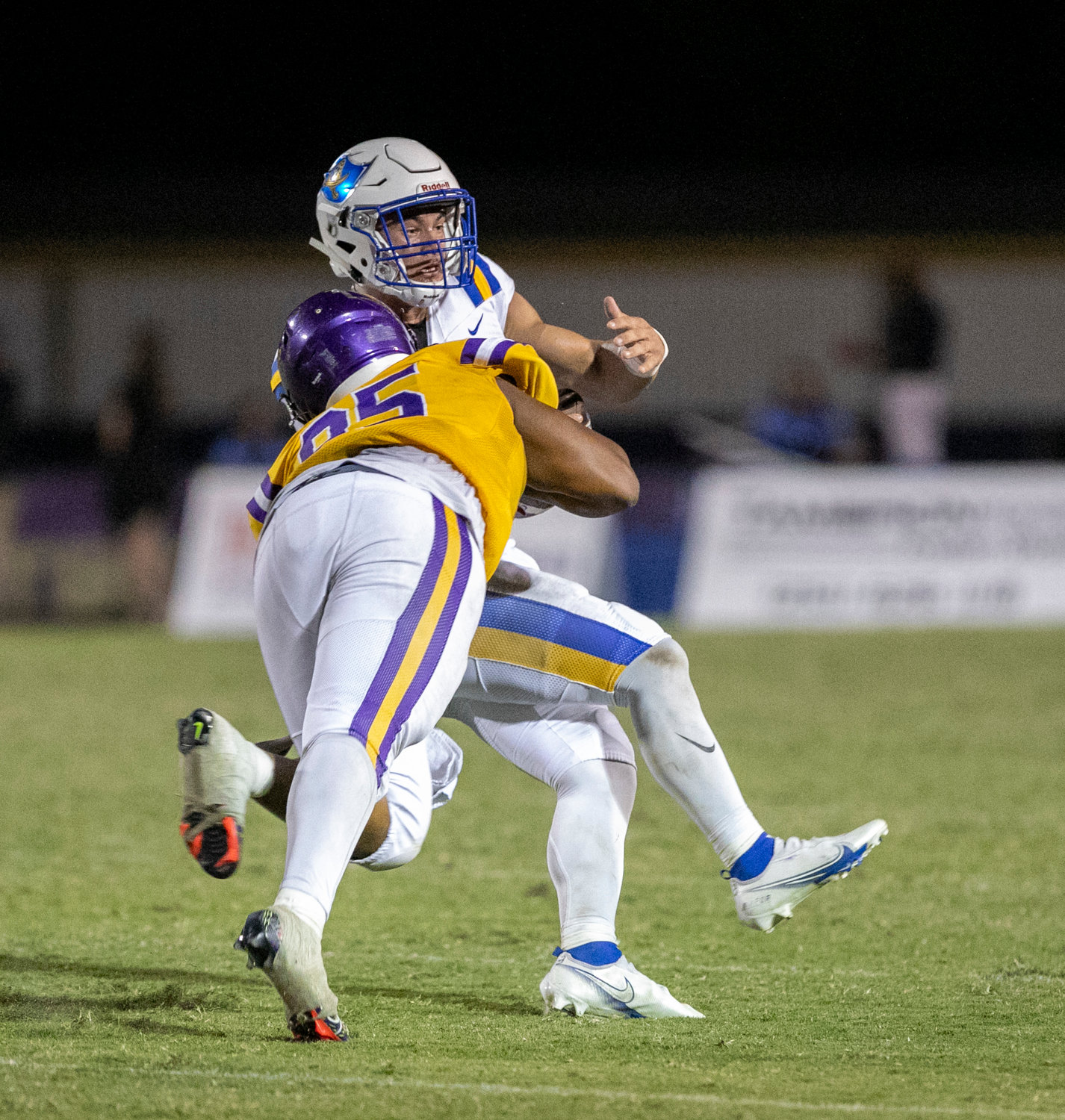 Daphne senior Johnnie Perdue corrals Fairhope quarterback Caden Creel for a sack in the first half of Friday’s rivalry game between the Trojans and Pirates at Jubilee Stadium Friday, Oct. 7.