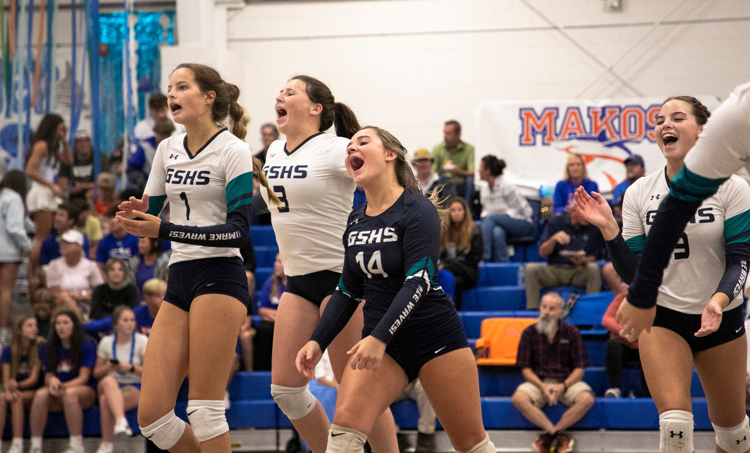 The Gulf Shores Dolphins celebrate while coming off the court for a timeout during their tri-match against Curry at Orange Beach High School Aug. 25. Gulf Shores claimed the Class 5A Area 1 tournament at home Wednesday night and take a No. 1 seed into the super regional bracket.