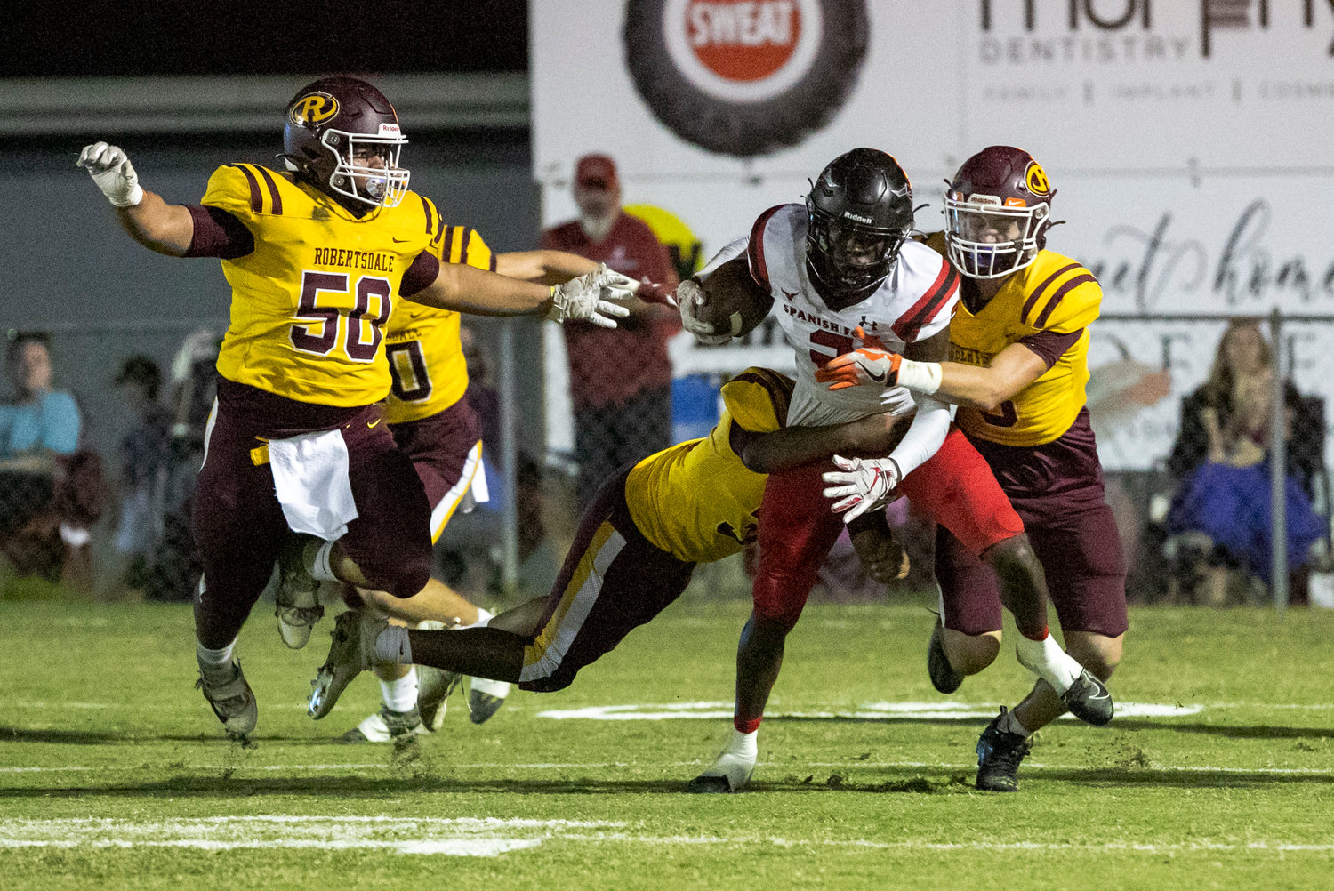 Spanish Fort receiver Khamron Jackson is corralled by a group of Robertsdale Golden Bears after a catch in the first half of the Class 6A Region 1 game at J. D. Sellars Stadium Friday, Oct. 14.