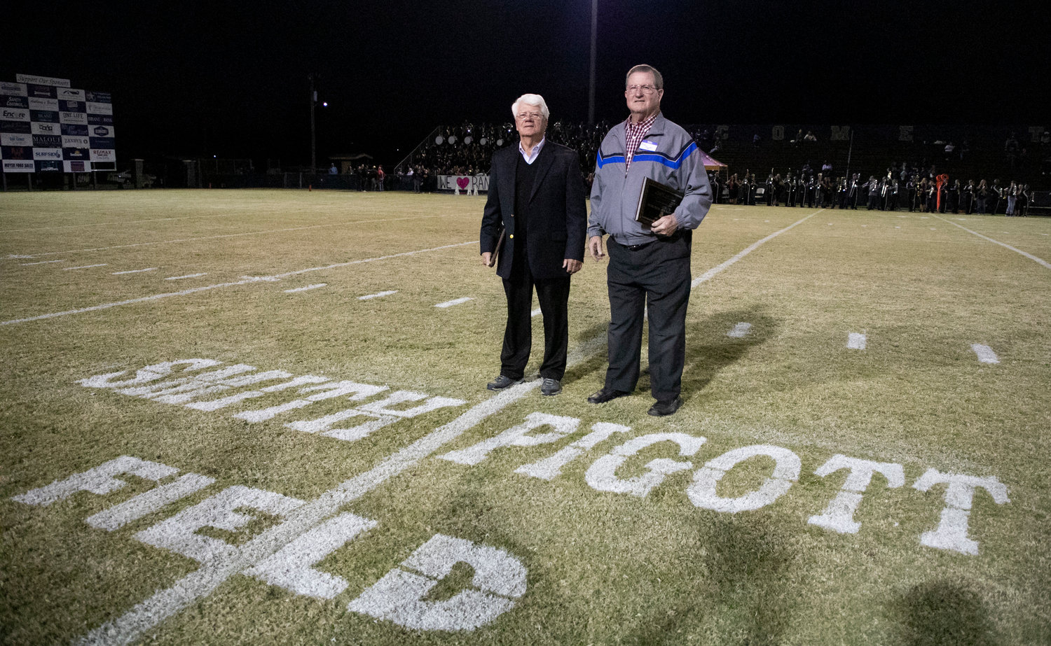 Former Foley head coach Lester Smith and defensive coordinator Bud Pigott were recognized with the unveiling of the newly named field at Ivan Jones Stadium Friday, Oct. 22, before the Lions’ region game against the Daphne Trojans.
