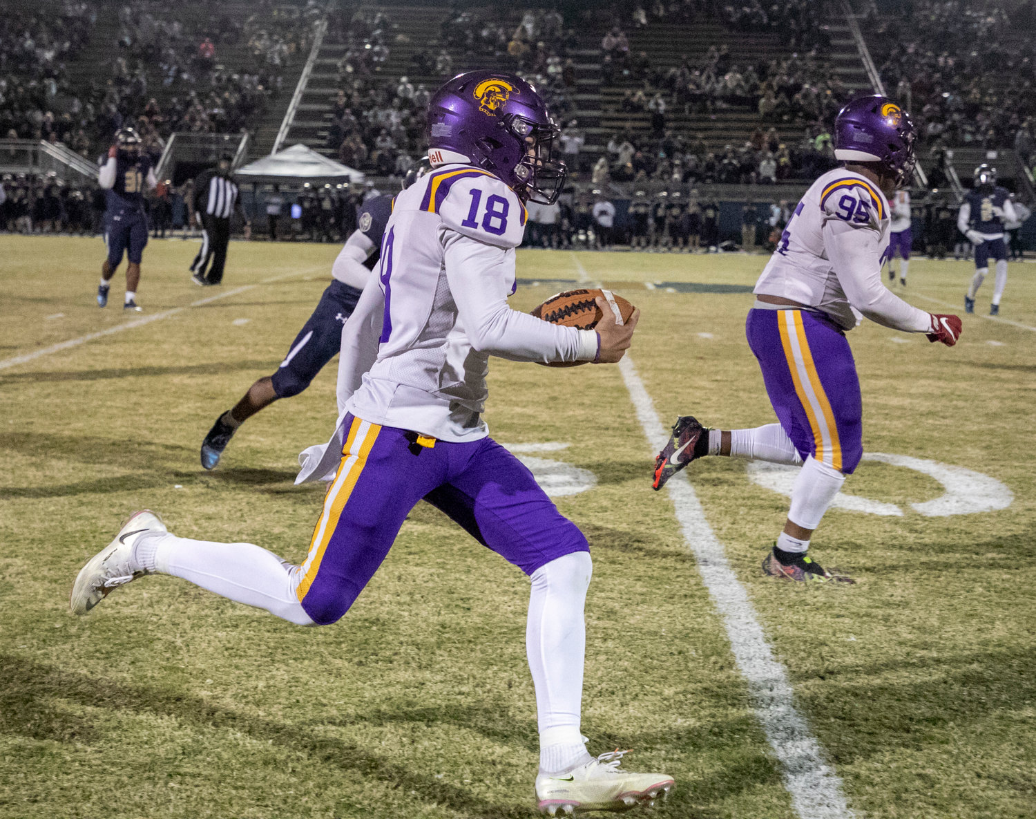 Daphne punter Baylor Beard hits the open field on his fake punt that extended the Trojans’ third-quarter drive Friday, Oct. 22, against the Foley Lions on the road.