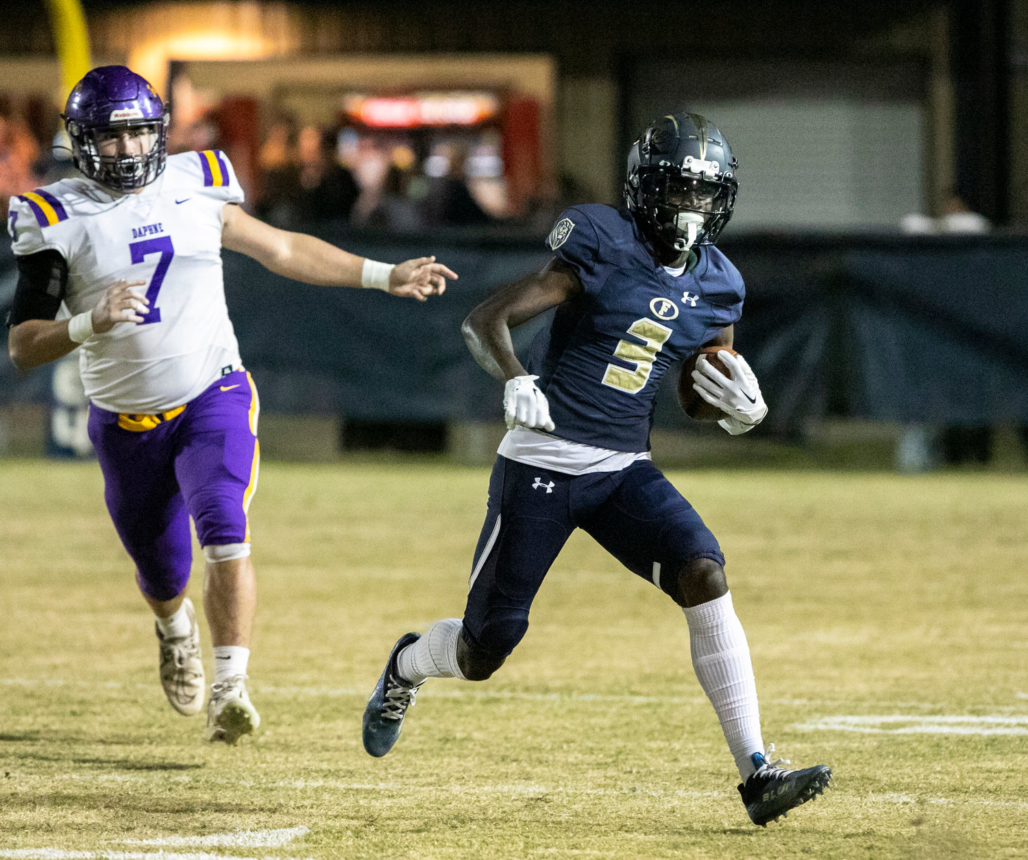 Foley receiver Harrison Knight hits the open field after a first-quarter catch in the Lions’ Friday home game against the Daphne Trojans for the Class 7A Region 1 title. Knight hauled in a touchdown pass in the third quarter to help Foley win 34-7.