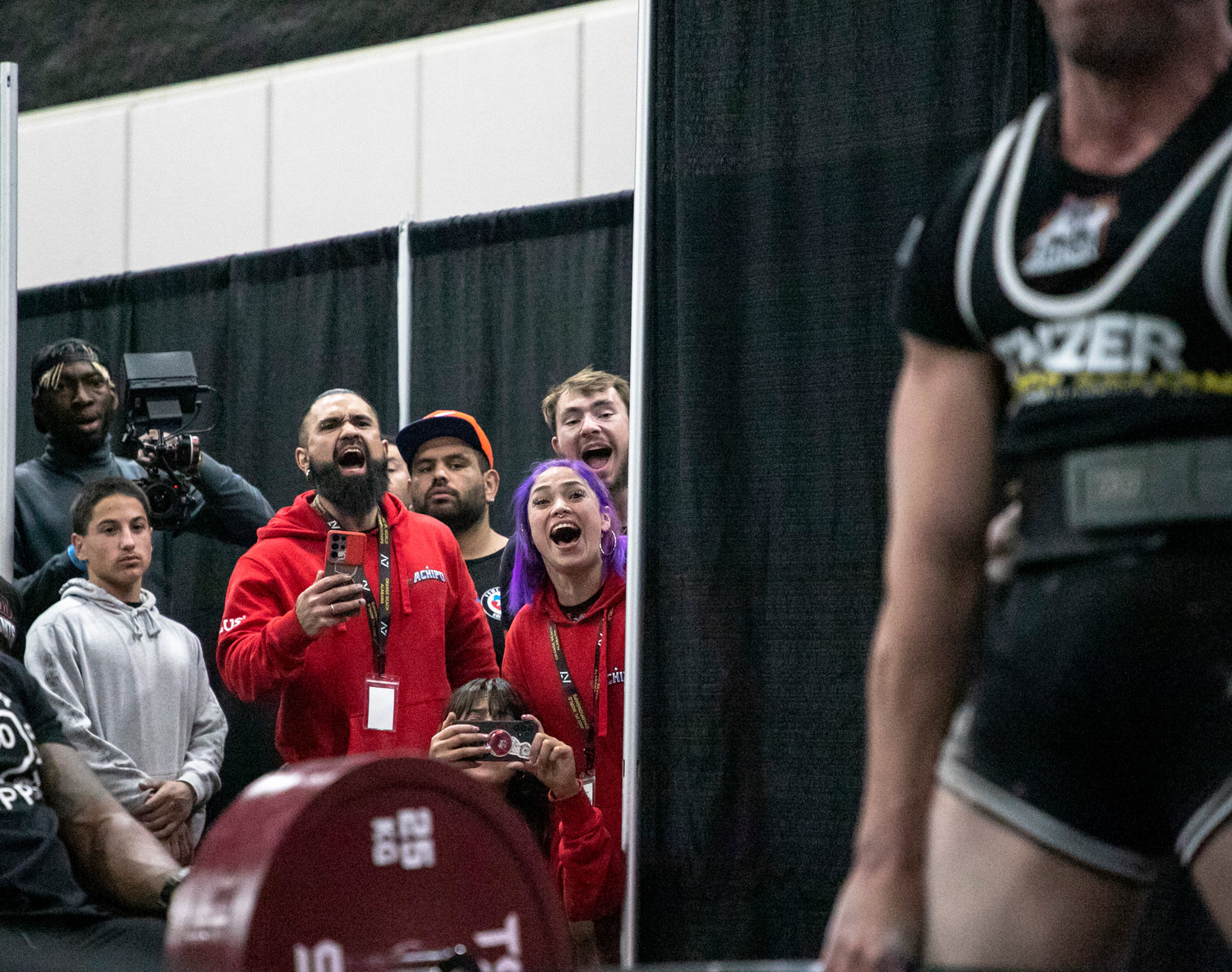Chilean supporters cheer on Matais Quiñinano Peñ to a national record-setting deadlift of 518.1 pounds (235 kg) at the World Championship meet of the International Powerlifting League Oct. 20 at the Orange Beach Event Center.