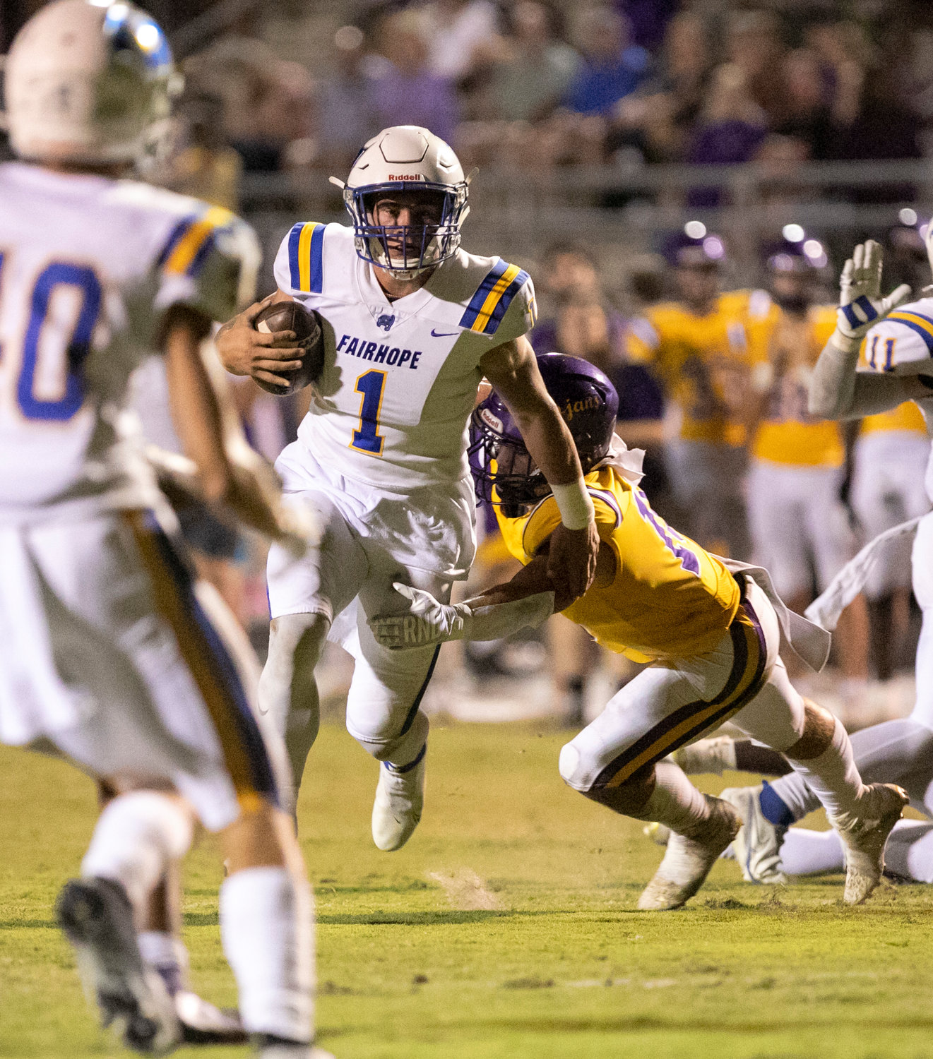 Fairhope senior quarterback Caden Creel sheds a tackle and looks upfield during the Pirates’ Class 7A Region 1 game against the Daphne Trojans at Jubilee Stadium Oct. 7. Fairhope qualified for its sixth consecutive postseason and will hit the road to open the playoffs Nov. 4.