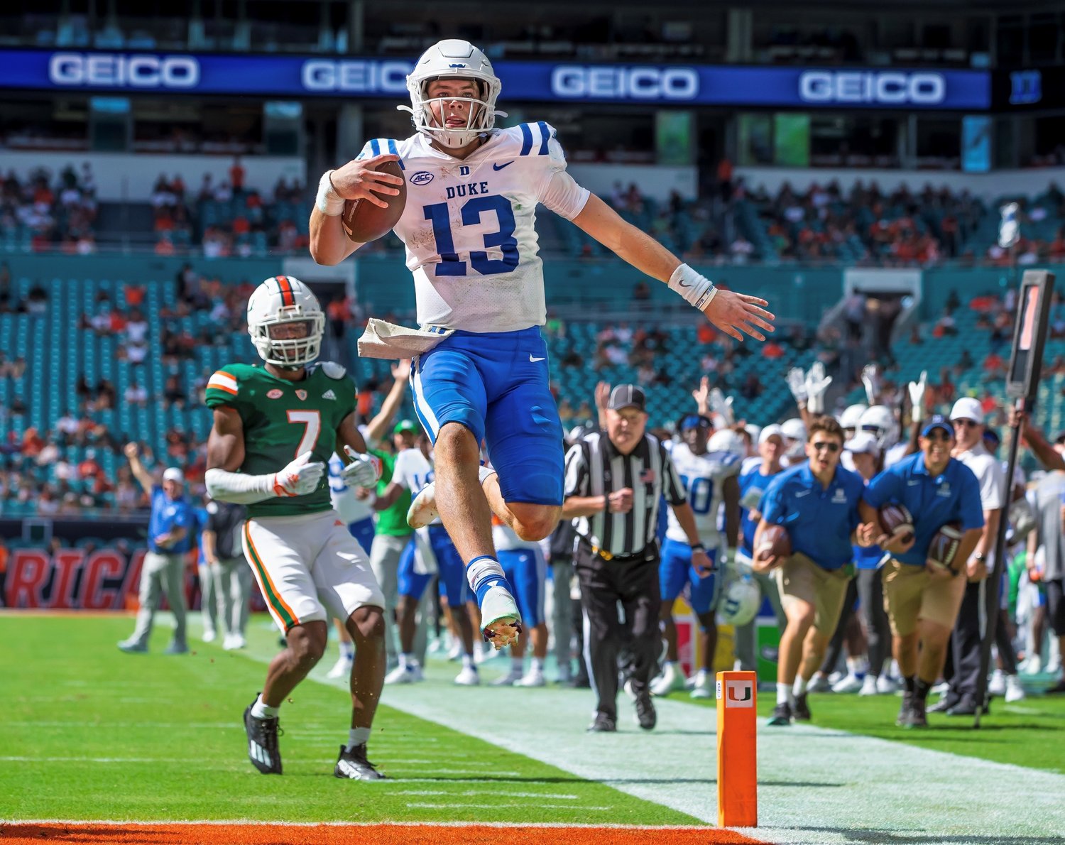 Duke sophomore quarterback Riley Leonard launches into the air as he crosses the goal line on his way to scoring his third rushing touchdown during the Blue Devils’ ACC matchup against the Miami Hurricanes Saturday at Hard Rock Stadium. The former Fairhope Pirate has been leading a resurgence of confidence and swagger in the Duke program.