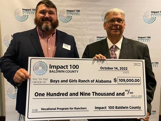 Representatives from the Baldwin County Boys' Ranch pose with their award from Impact 100 at the annual awards banquet last week.