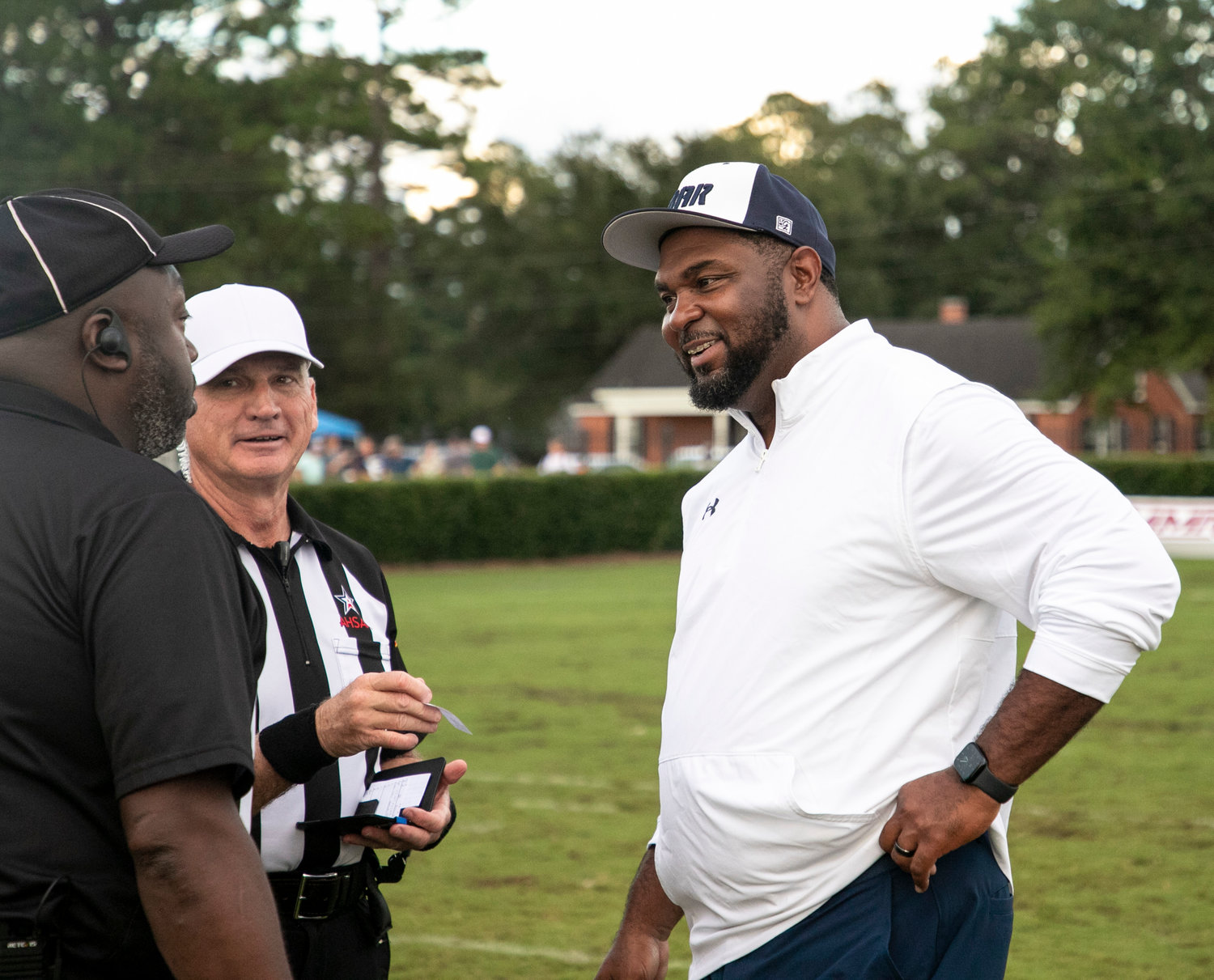 Foley head coach Deric Scott meets with the officials before the Lions’ non-region contest against the Baldwin County Tigers in Bay Minette Aug. 26. Scott was named to the coaching staff of the South All-Stars for the 64th annual AHSAA All-Star game set for Dec. 16.