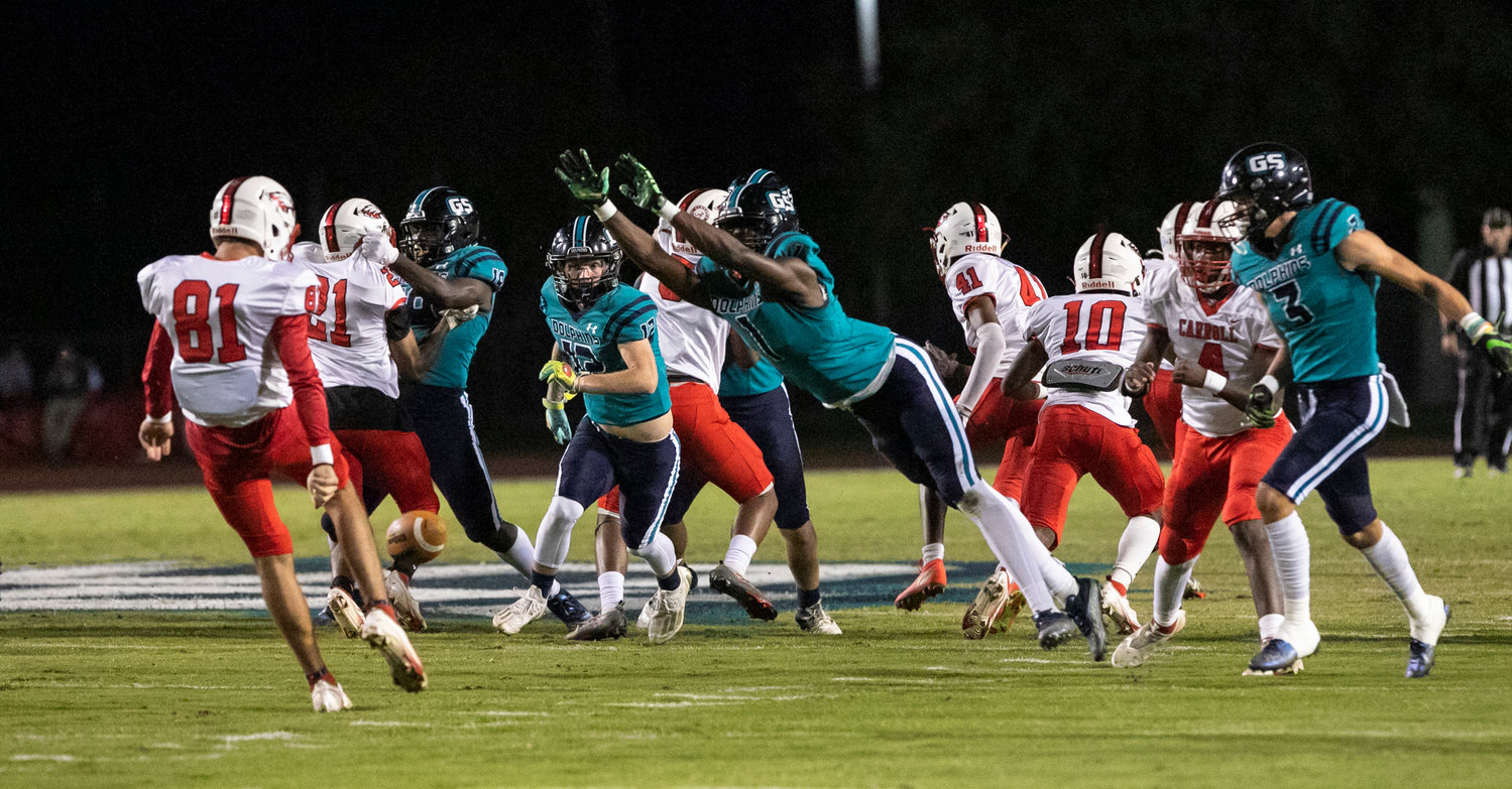 Dolphin junior Braden Jackson leaps for a block attempt on a first-half punt during Gulf Shores’ home playoff game against Carroll Friday, Nov. 4. Jackson caught a touchdown pass to help the Dolphins down the Eagles 42-0 and advance to the second round.
