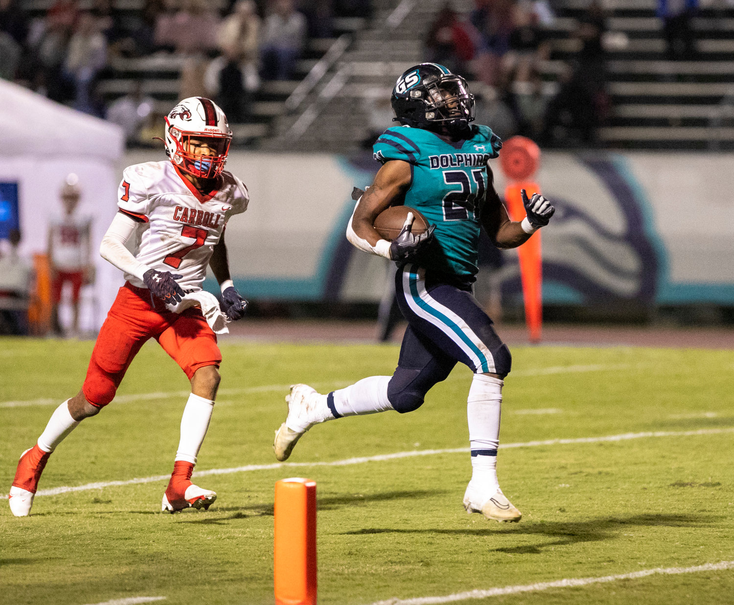 Gulf Shores senior JR Gardner cruises into the end zone on a 45-yard receiving touchdown from Brendon Byrd in the third quarter of the Dolphins’ first-round playoff game against the Carroll Eagles at Mickey Miller Blackwell Stadium Friday night. Gardner added a rushing touchdown to the 42-0 victory.