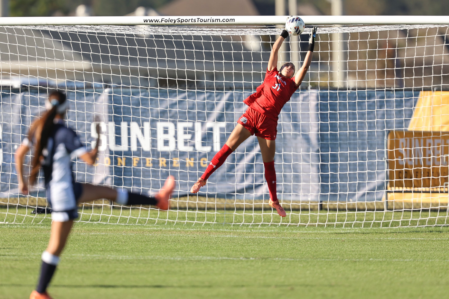 Monarch junior Erin Jones leaps to make a save during the Sun Belt Conference Championship match between Old Dominion and James Madison Sunday afternoon in Foley. The Monarchs beat the Dukes 4-3 in overtime to win the conference championship in their first year of competition.