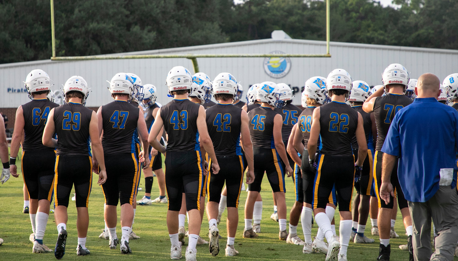 The Fairhope Pirates head back to the locker room before their season-opening contest against the Spanish Fort Toros Aug. 19 at Fairhope Municipal Stadium. The fieldhouse outside of W. C. Majors Field will soon be named after longtime Pirate head football coach Joe Dean.