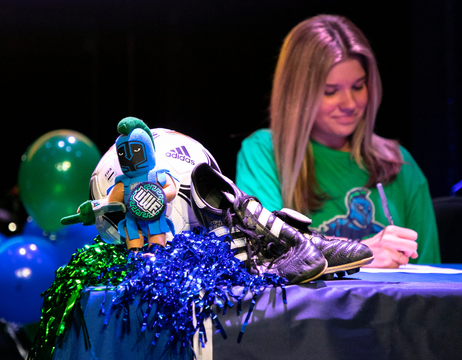 Addison Smith checks her signature on her National Letter of Intent during the Nov. 10 signing ceremony at 3Circle Church in Fairhope. Although Smith tore her ACL a little over a month after committing to the West Florida soccer program, the coaches had no doubt she’d return even stronger.
