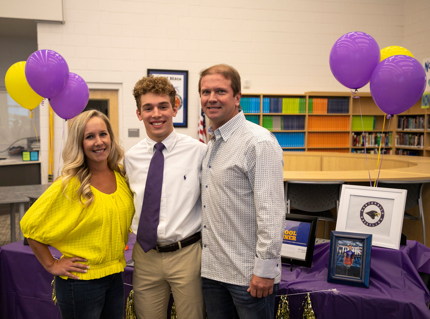 Shayd Arboneaux and his parents celebrated the wrestler’s signing with the University of Montevallo wrestling team in the Orange Beach High School Media Center Monday, Nov. 14, as part of the first wave of National Signing Day.