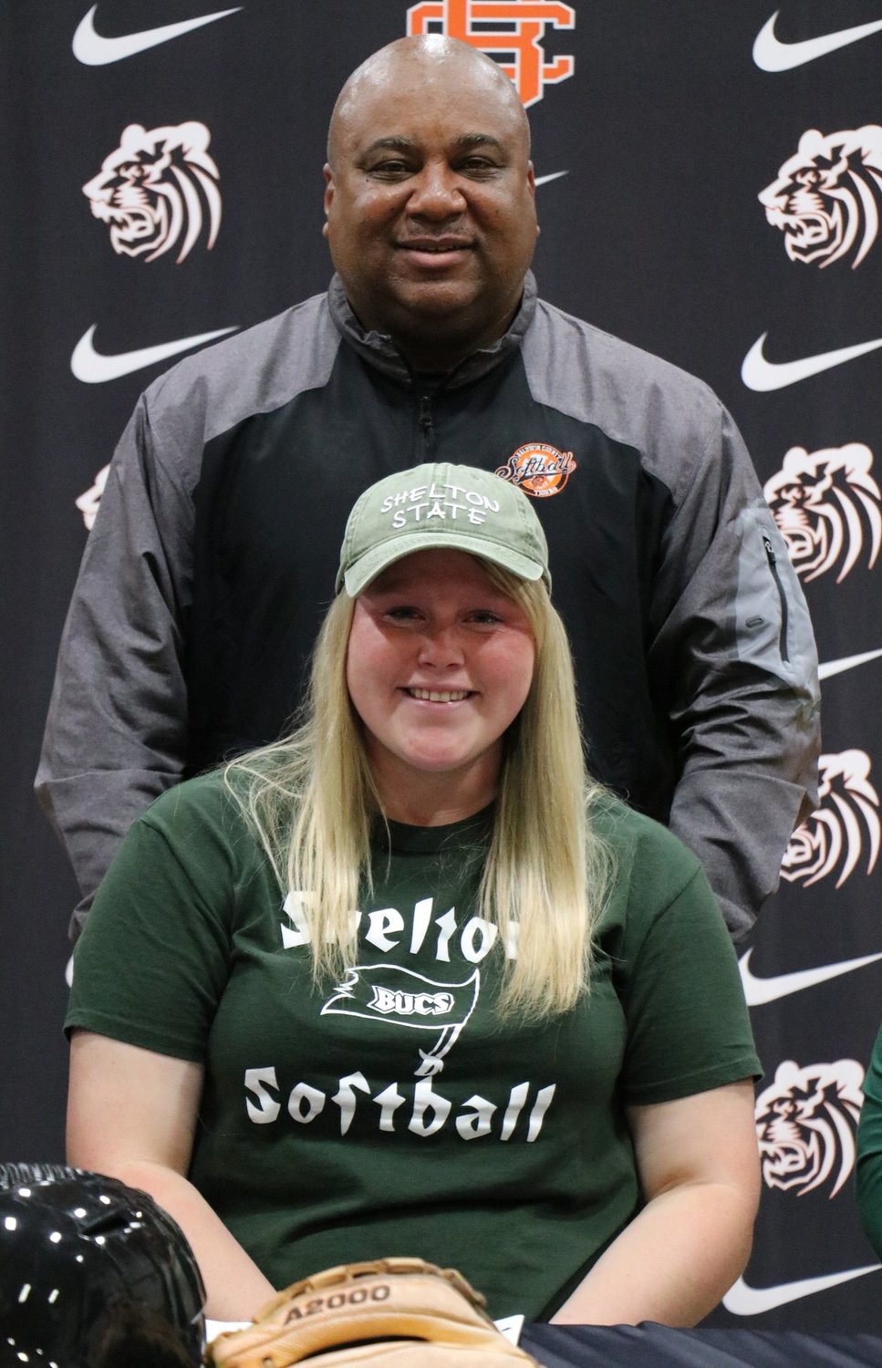 Baldwin County head softball coach Anthony Cox celebrated Aspen Gerald’s signing with the Shelton State Buccaneer softball team Friday, Nov. 18, during a signing ceremony at the high school. Gerald has played four varsity seasons for Cox already and has recorded a batting average of .350 with 100 RBIs.