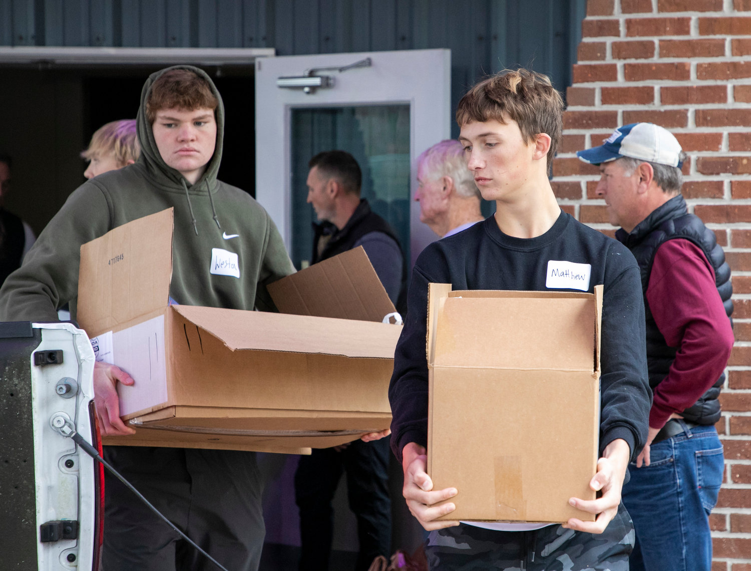 Matthew Steele and Weston Lee were among Orange Beach High School students who were part of the over 100 volunteers helping distribute Thanksgiving meals at The Island Church Nov. 19. The Island Mobile Food Pantry saw its largest turnout yet with 222 families signed up.