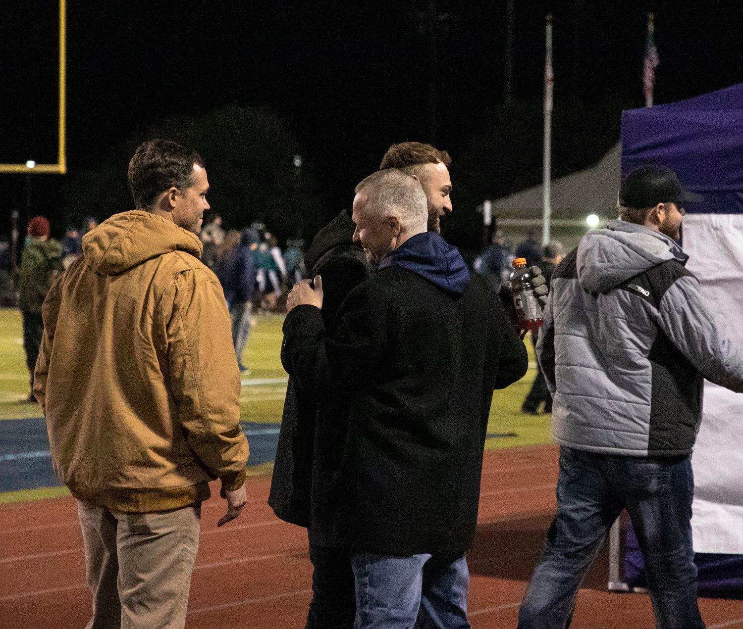 Gulf Shores athletic director Kevin Tubbs greets Dolphin football alumni JD Swiger and Joethan Phillips after the former players were honored with a pregame ceremony ahead of Gulf Shores’ third-round playoff game against Faith Academy at home Friday, Nov. 18.