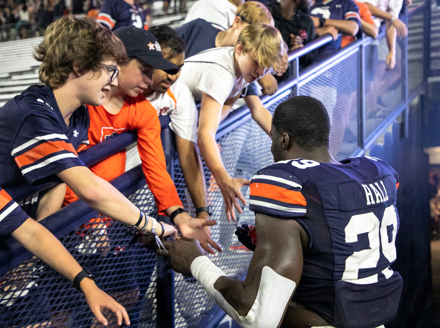 Derek Hall gifts a glove to young Auburn fans following the Tigers’ non-conference win over the San Jose State Spartans Sept. 10. Hall was one of three Auburn players named all-conference in 2022.