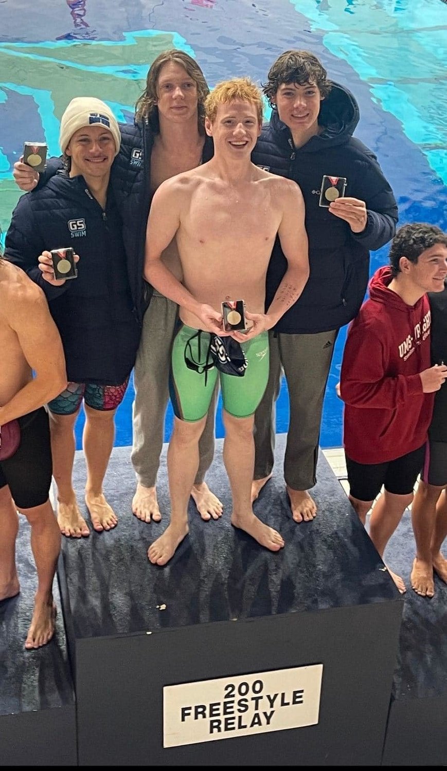 Gulf Shores’ 200-yard freestyle relay team, including Murray Reed, Canyon Moyers, Liam Bickham and Patrick Conley, stand atop the podium after breaking the Class 1-5A state meet record with a time of 1:28.09 at the championship meet in Auburn last weekend.