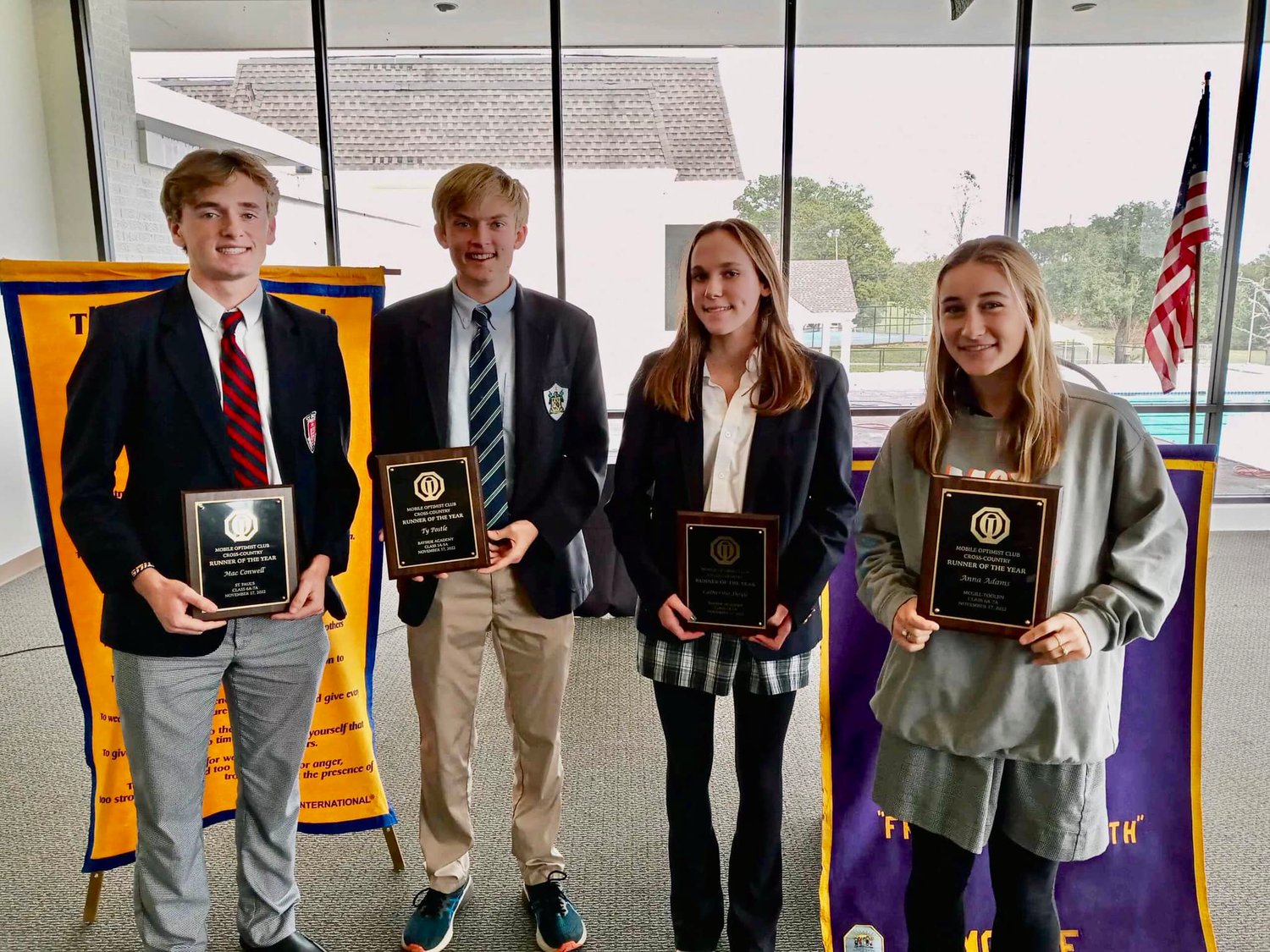 Bayside Academy’s Ty Postle and Catherine Doyle, center, were selected as the Baldwin County Runners of the Year as awarded by the Mobile Optimist Club. They were joined by Mac Conwell from St. Paul’s and Anna Adams from McGill-Toolen in being recognized at the Nov. 17 luncheon.