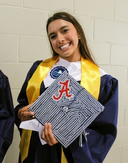 A student shows off her cap during graduation in Spring 2022.
