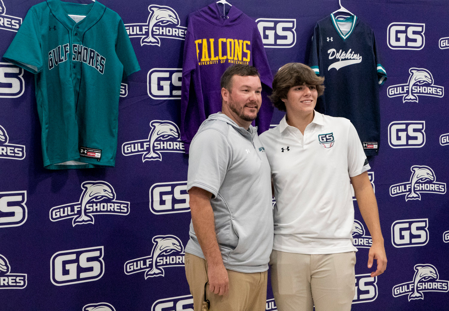 Gulf Shores head baseball coach Chris Jacks poses for a picture with catcher Dominic Maldet after he signed with the University of Montevallo’s baseball team after his time with the Dolphins. Maldet became the eighth baseball player to sign with a college in Jacks’ seven years at the helm.