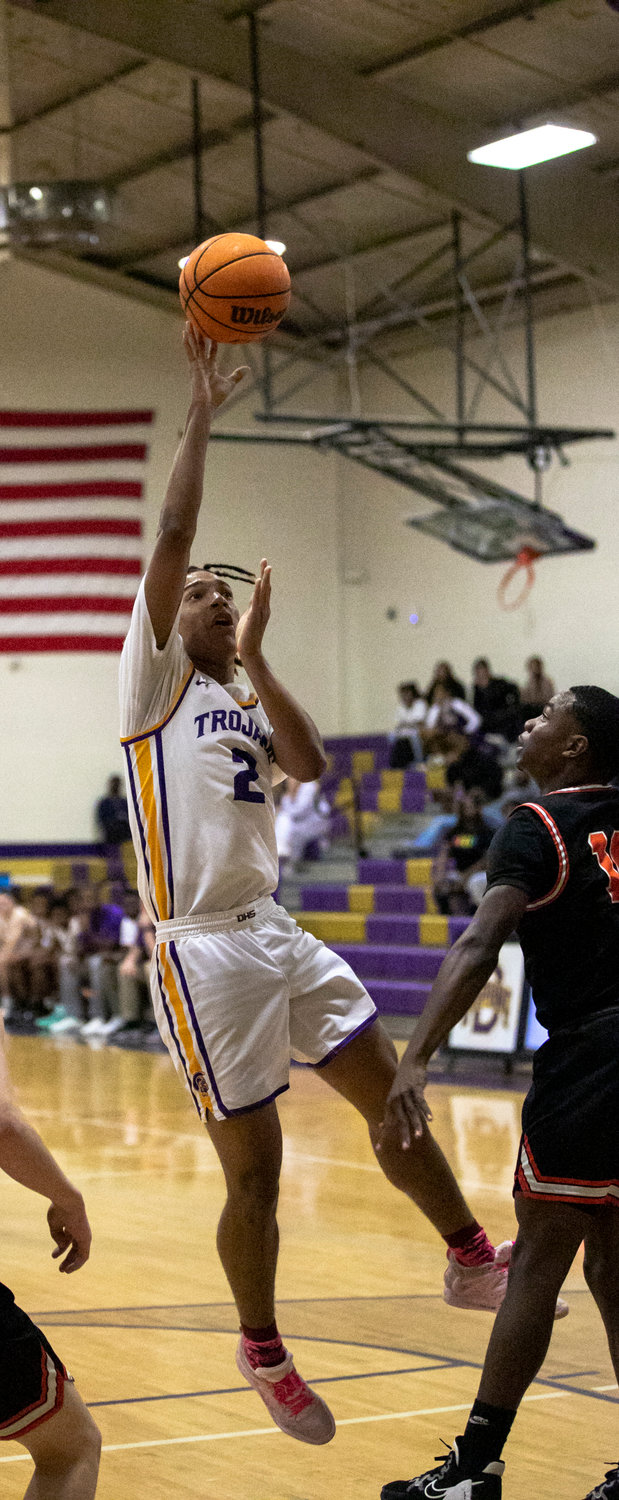 Trojan senior Randy Williams floats in the lane with a shot attempt in the first half of Daphne’s home contest against Baldwin County Tuesday night, Dec. 13. Williams collected 15 points including nine in the fourth quarter to help the host Trojans complete a comeback and earn a 59-57 win over the Tigers in non-area action.