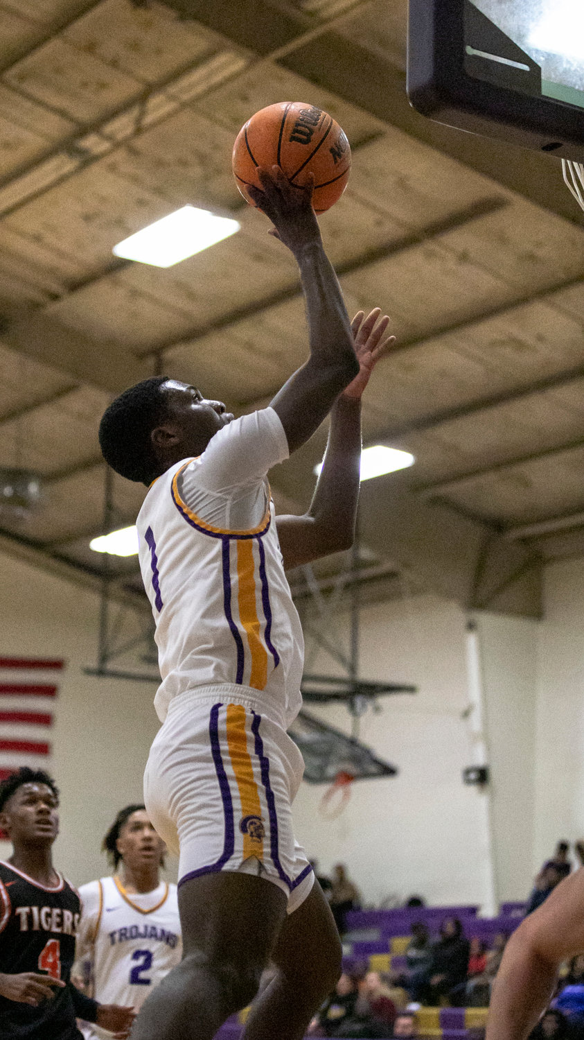 Daphne senior Donovan Wilson lays in a bucket in the first half of the Trojans’ non-area contest against Baldwin County at home Tuesday, Dec. 13. Wilson led the team with 18 points to register his 1,000th for his career so far.