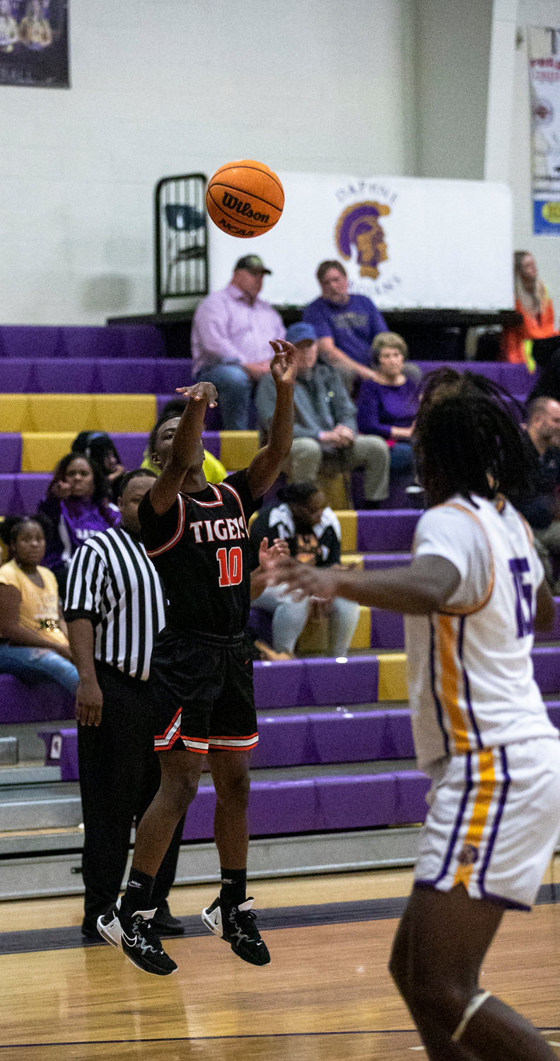 Baldwin County junior Alonzo Griffin lifts a three-point attempt during the third quarter of the Tigers’ away non-area game against the Daphne Trojans Tuesday night, Dec. 13. Griffin led the team with 15 points where nine points came from beyond the three-point arc.