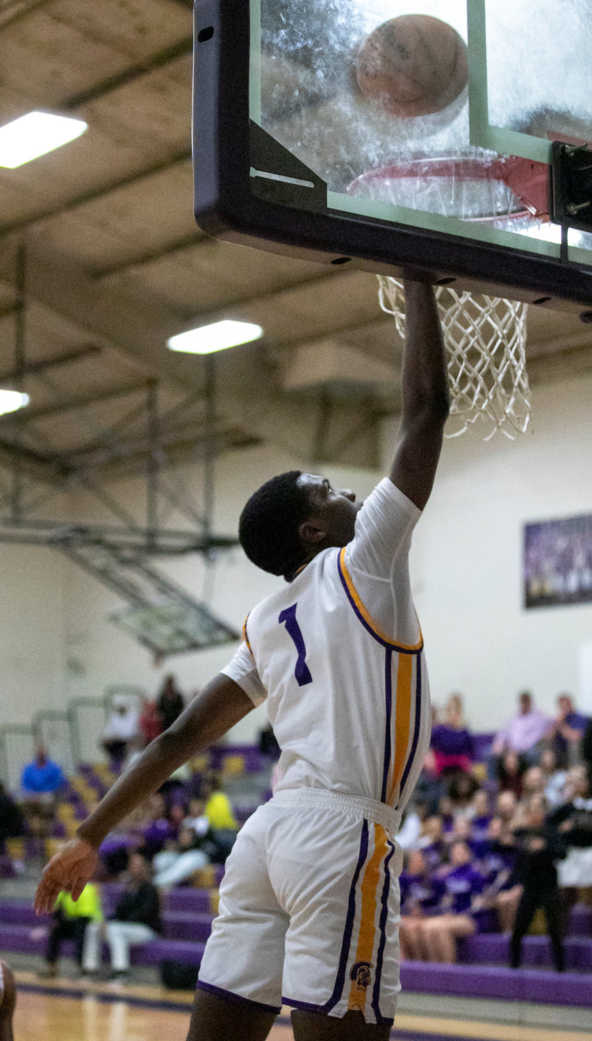 Trojan senior guard Donovan Wilson lays in two of his nine third-quarter points that helped Daphne mount a comeback against Baldwin County Tuesday night at home and emerge with a 59-57 win. Wilson finished with 18 points on the night and recorded his 1,000th career point for the Trojans so far.