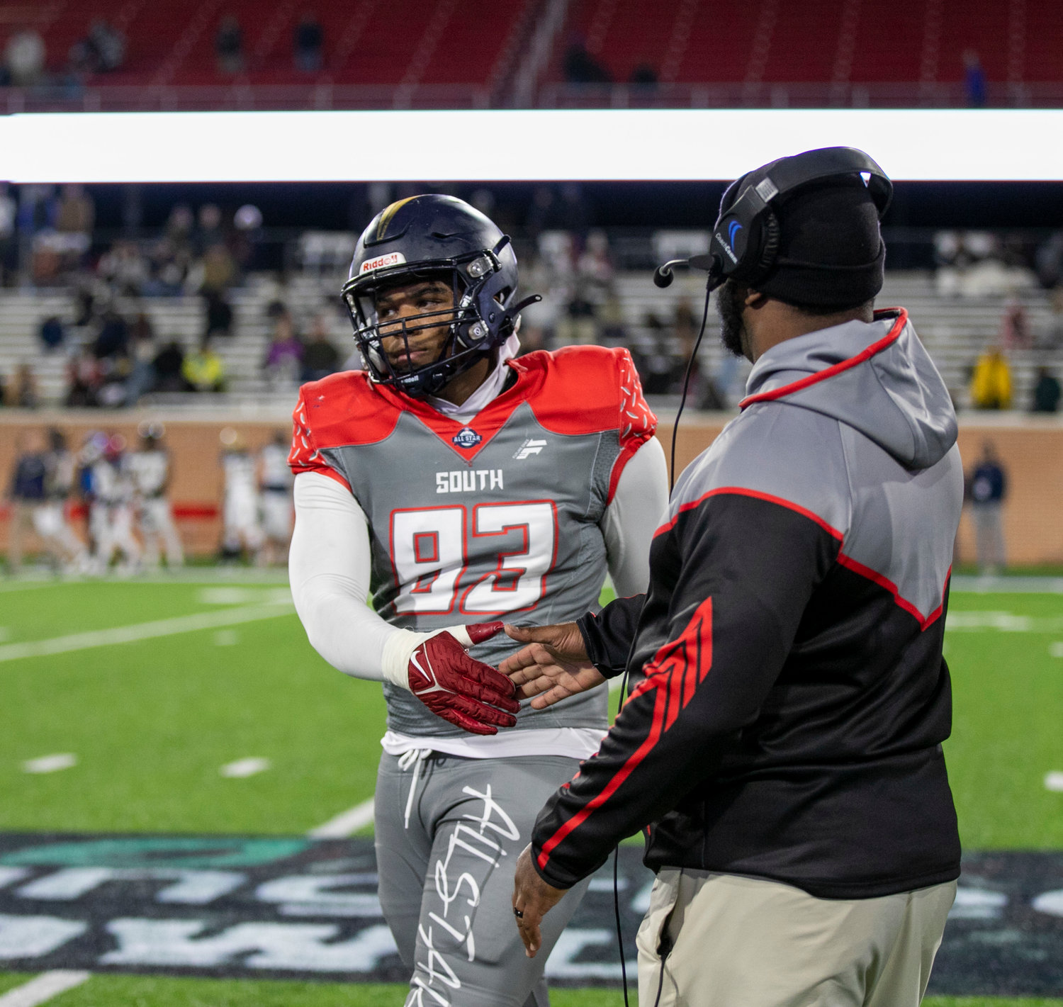 Foley head coach Deric Scott acknowledges AJ Prim as he comes off the field at the end of Friday’s all-star football game at the University of South Alabama. Prim collected four tackles in the South’s 42-7 win that marked a second straight victory.
