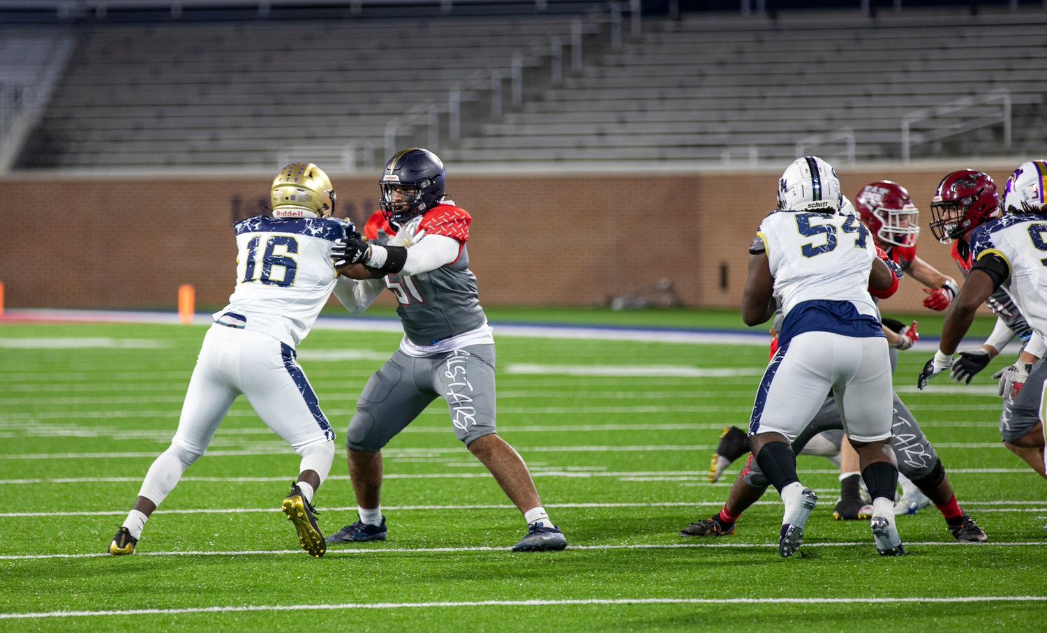 Foley senior Cameron Schultz engages with a North All-Star defensive lineman on a pass play during the AHSAA all-star football game on Abraham A. Mitchell Field at Hancock Whitney Stadium in Mobile Friday, Dec. 16.