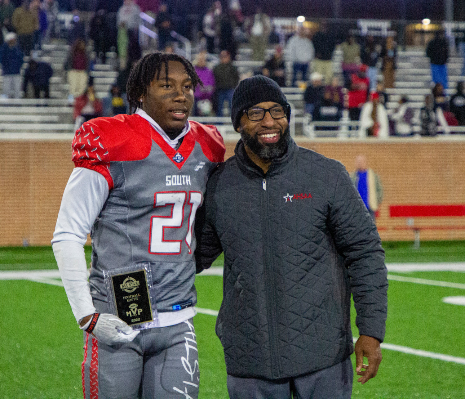 Orange Beach’s Chris Pearson receives his MVP trophy from AHSADCA Director Brandon Dean after the 64th annual AHSAA All-Star Football Classic Friday night at Hancock Whitney Stadium in Mobile. Pearson returned an interception and a punt for a touchdown in the South All-Stars’ 42-7 win.