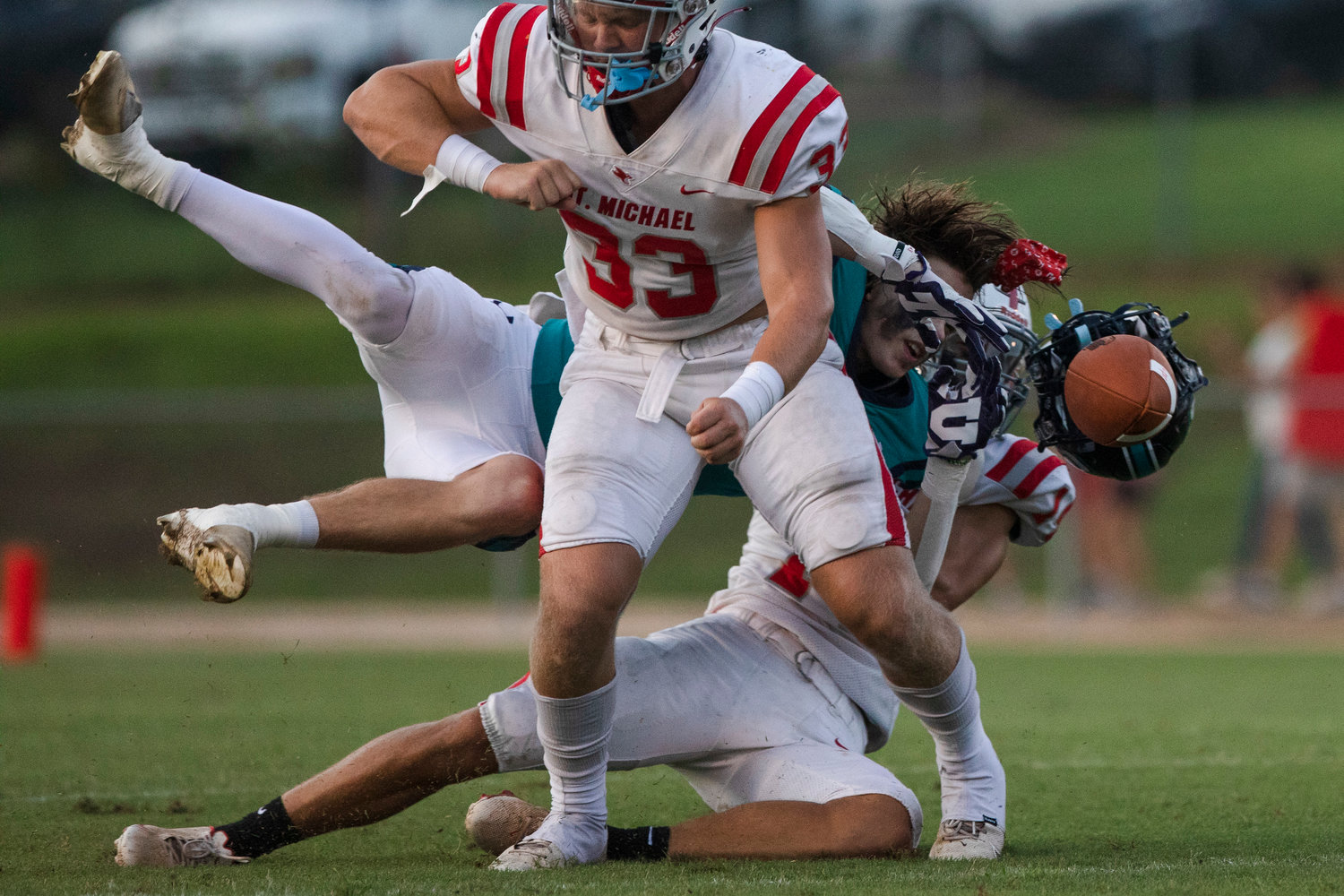 St. Michael senior Clay Barr separates Gulf Shores’ Nick Carris from a reception during the Cardinals’ season-opening game against the Dolphins at Fairhope Municipal Stadium Aug. 18. Barr closed his high school career as a second-team all-state linebacker.