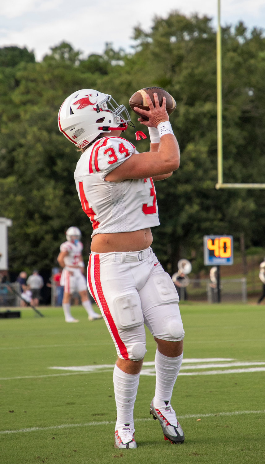 St. Michael’s Tyler Cella catches a pass in warmups before the season-opening contest against Gulf Shores at home Aug. 18. The senior linebacker was one of two Cardinals named all-state by the Alabama Sports Writers Association.