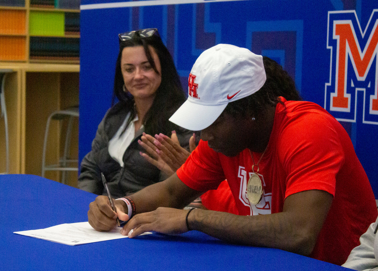 Orange Beach senior Chris Pearson puts pen to paper to confirm his commitment to the Houston Cougar football team during a Wednesday ceremony at the high school. Pearson became the first college football signee in Mako history.