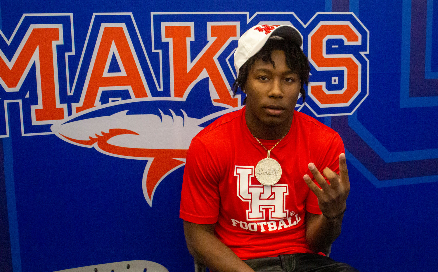 Chris Pearson puts up the University of Houston hand gesture after he cemented his commitment to the University of Houston football program as part of National Signing Day Wednesday, Dec. 21, during a ceremony at Orange Beach High School.