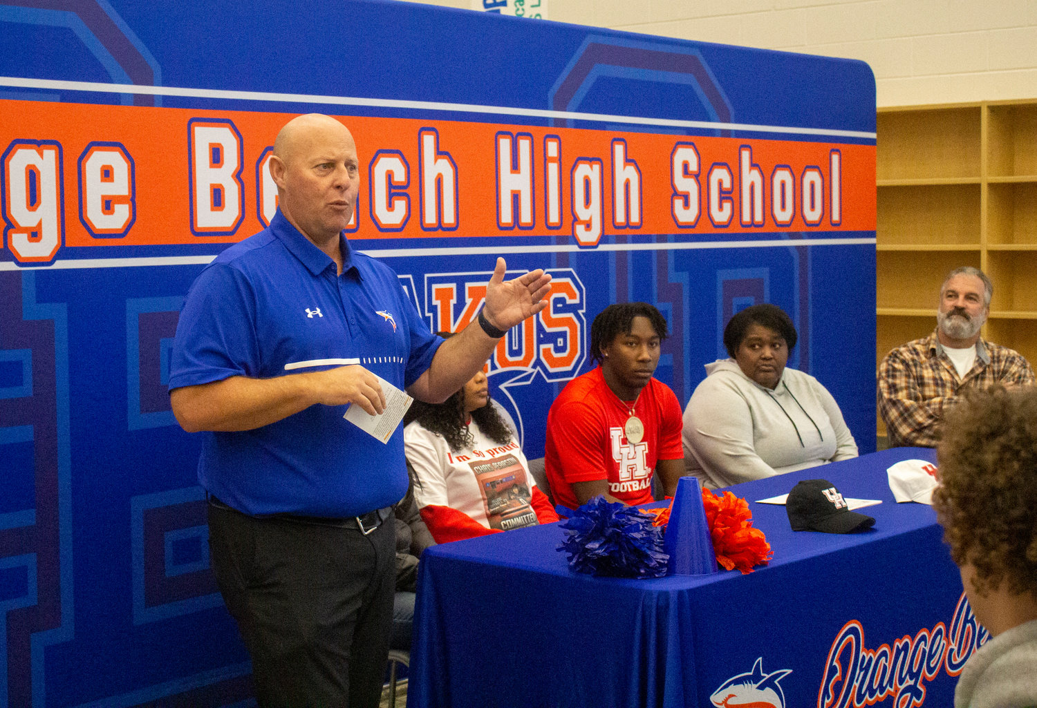 Orange Beach head football coach Jamey DuBose greets those in attendance of the Wednesday signing ceremony where Chris Pearson became the first Mako football player to sign a Division I National Letter of Intent with the Houston Cougars.