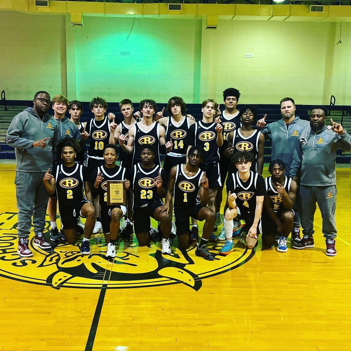 The Robertsdale Golden Bears pose with the McIntosh Christmas Tournament championship plaque after Robertsdale took down St. Luke’s and Alma-Bryant to extend a winning streak to 10 games.