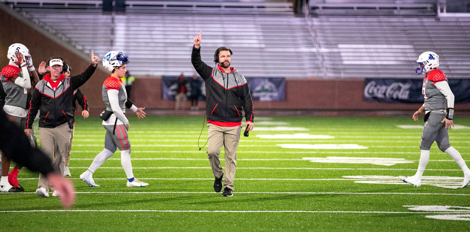 Offensive line coach Chase Smith (Spanish Fort) and head coach Erik Speakman (Opelika) signal for a one-point PAT after a touchdown during the AHSAA North-South All-Star Football Classic at Hancock Whitney Stadium in Mobile Dec. 16. Smith was one of three coaches and eight players on the South All-Star Roster from Baldwin County.