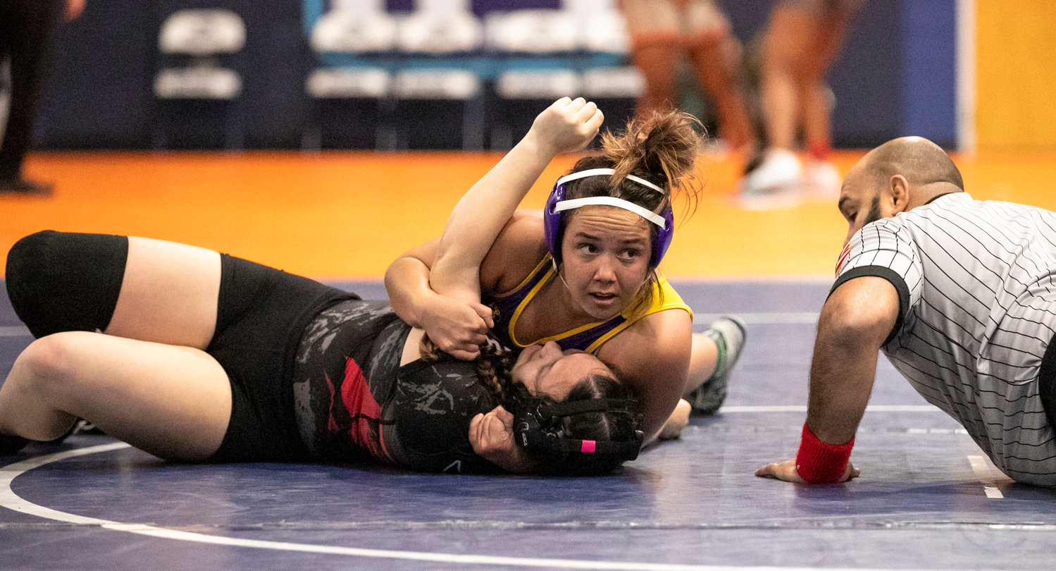 Daphne’s Kalee Holder finishes off a pin of Spanish Fort’s Sarah Edgar in the finals of the 165-pound class at the Baldwin County Championships Friday night at Gulf Shores High School. Holder was one of seven Daphne wrestlers to win an individual title to help the Lady Trojans claim the team championship as well.