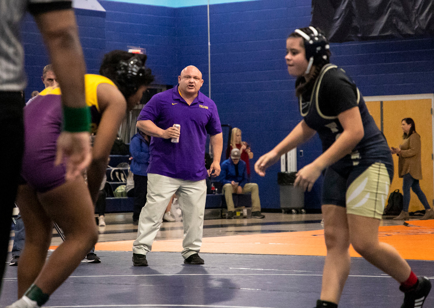 Daphne head wrestling coach Greg Jefcoat guides Taliah Wade during her semifinal match in the 152-pound class at the Baldwin County Championships Friday night in Gulf Shores. The Lady Trojans went on to win the team title with seven individual champions and eight more top-four finishers.