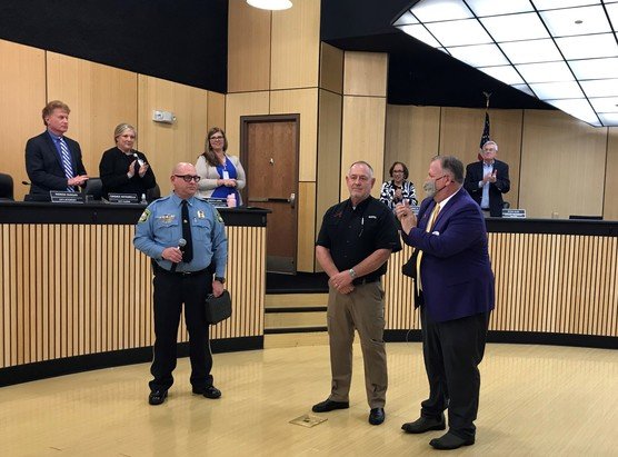 Daphne Mayor Robin LeJeune, right, and city officials recognize new Police Chief Brian Gulsby, left, and retiring Chief David Carpenter, center, at the city council meeting, Tuesday, Jan. 3.