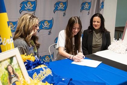 Fairhope senior Michelle Bossard put pen to paper to confirm her commitment to the University of Mobile competitive cheer team Friday, Jan. 6, at First Baptist Church. The Pirate cheerleader recently represented her team at the Citrus Bowl as an All-American Cheerleader.