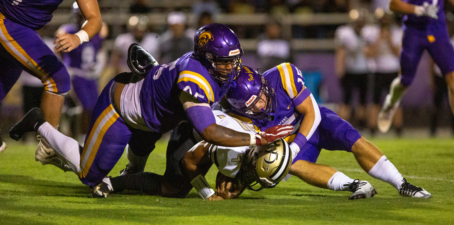 Daphne seniors Johnnie Perdue (95) and Garrett Childress (15) meet to take down a Davidson ballcarrier during the Trojans’ Class 7A Region 1 contest against the Warriors Sept. 9, 2022, at Jubilee Stadium. The pair was both named to the second-team all-county defense for their efforts in their final seasons.