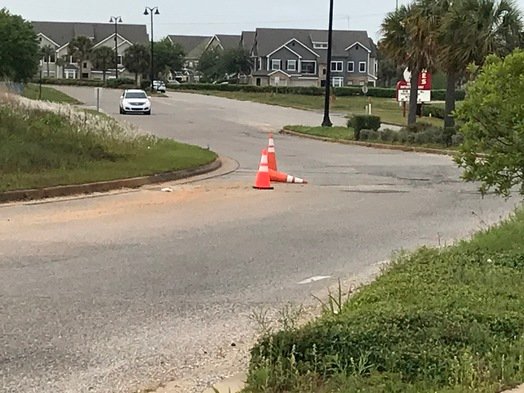 Traffic cones mark road hazards in the Eastern Shore Center in Spanish Fort before the start of repairs. Work to repair and repave roads at the site is scheduled to be completed in February.