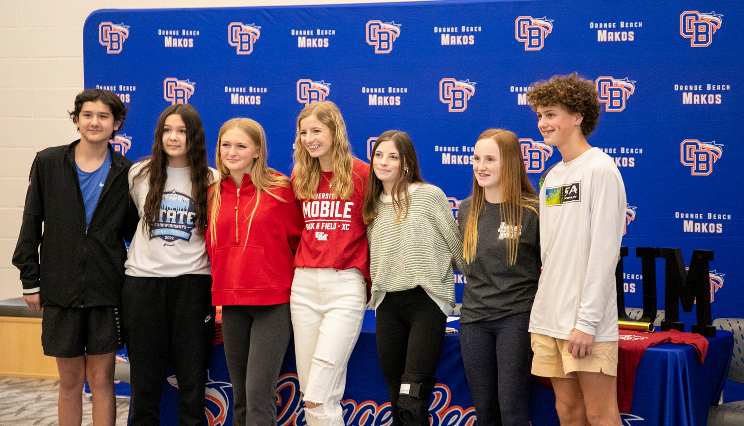 Orange Beach cross country runners celebrated their teammate Claire Atkins signing with the University of Mobile Ram squad after the signing ceremony in the media center at the high school Wednesday, Jan. 18.